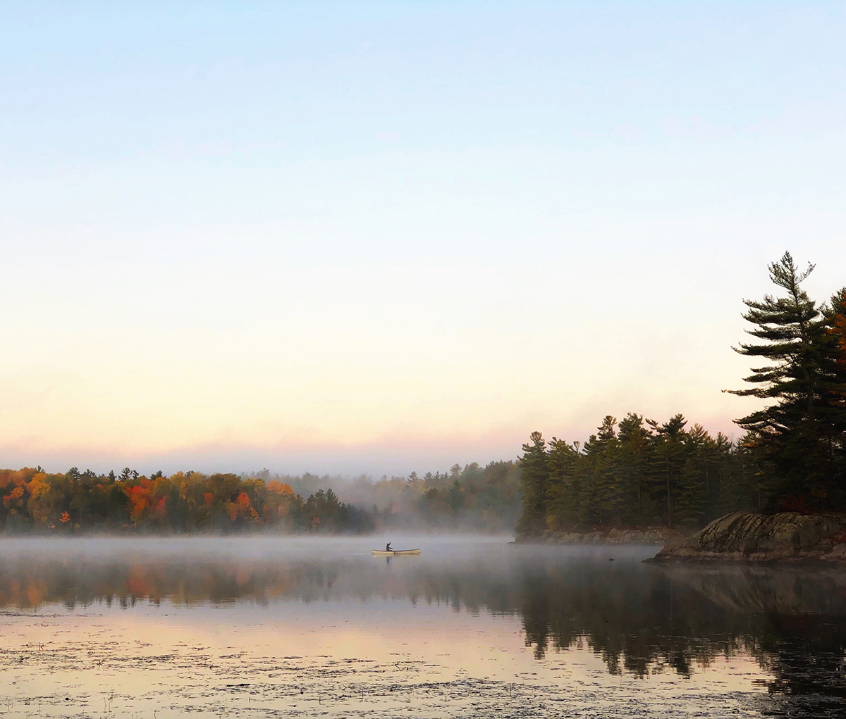 Fall camping guide tip: paddle early in the morning to get a view of the sunrise and misty mornings.

A woman canoes on a misty morning at La Peche Lake in Gatineau Park. 